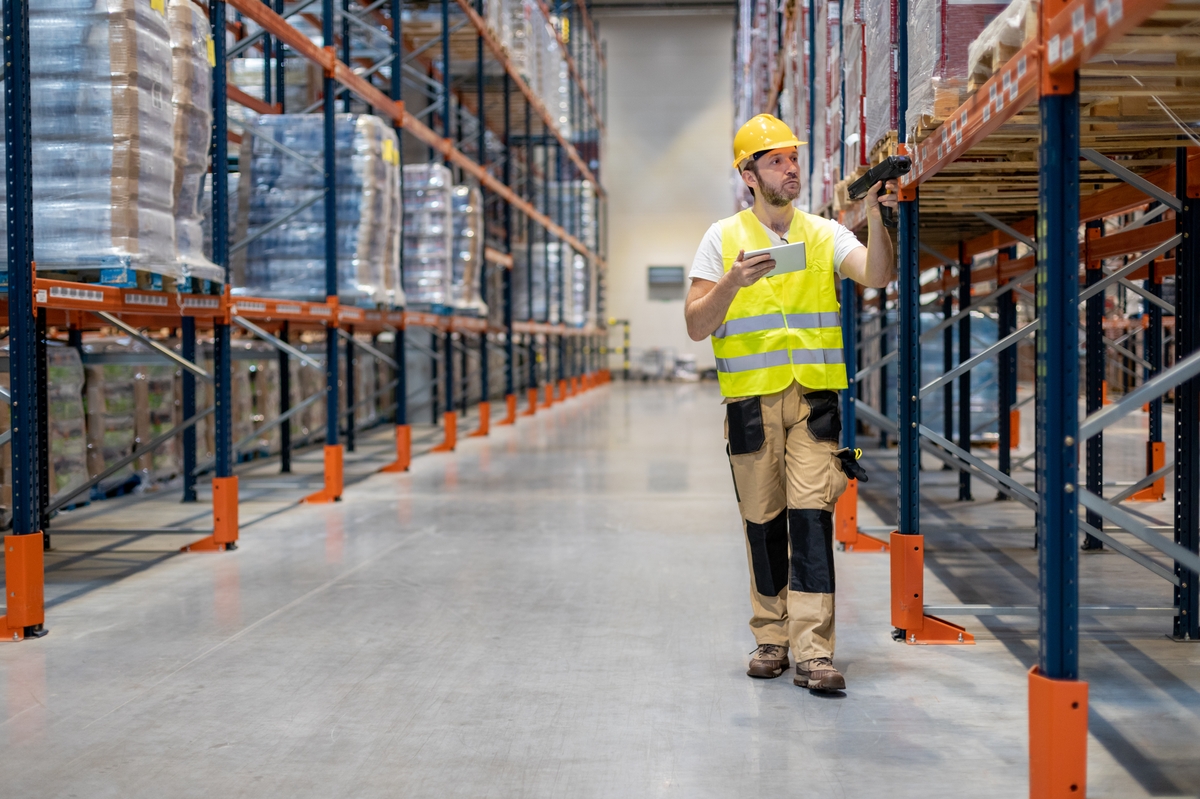 worker-scanning-package-in-warehouse-2023-11-27-05-19-21-utc